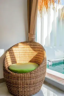 a rattan chair sitting in front of a window at Modern 2BR Villa in Seminyak Center - Private Pool in Seminyak