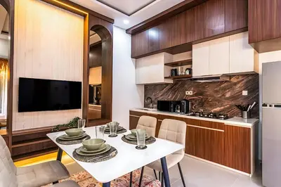 a kitchen and dining room with a white table and chairs at Modern 2BR Villa in Seminyak Center - Private Pool in Seminyak