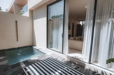 a swimming pool in the middle of a house at Suom Apartments and Villas Canggu in Canggu