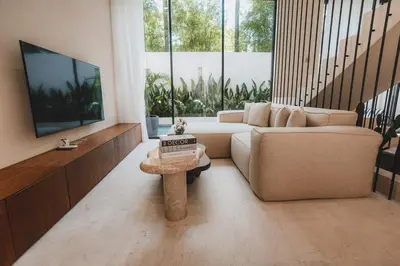 a living room with a couch and a table at Suom Apartments and Villas Canggu in Canggu
