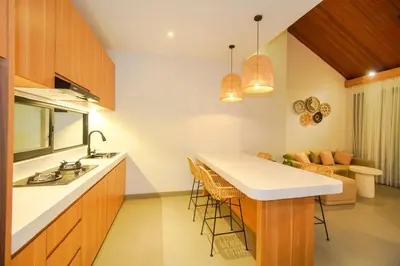 a kitchen with a counter and a island in a room at Rama Villa Umalas in Kerobokan