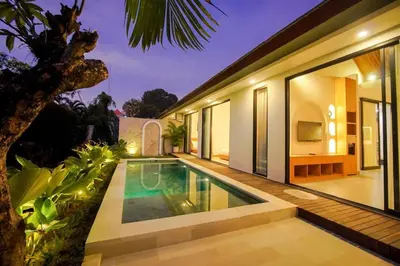 an external view of a villa with a swimming pool at Rama Villa Umalas in Kerobokan