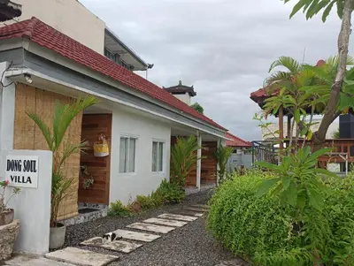 a house with a sign that reads davis squad villa at Dongsoul Guest House in Legian