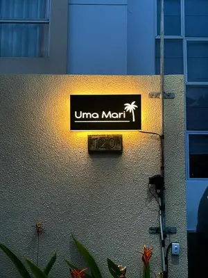 a sign on the side of a building at Uma Mari Villa Seminyak in Seminyak