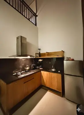 a kitchen with a stove and a sink and a refrigerator at Uma Mari Villa Seminyak in Seminyak