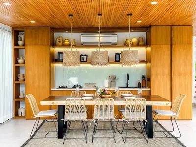 a dining room with a table and chairs at Desa Hut - 2BR Tropical Ricefield Villa near Seminyak in Kerobokan