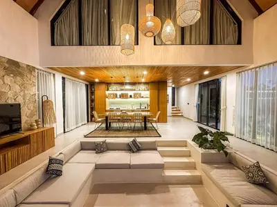 a living room with a couch and a table at Desa Hut - 2BR Tropical Ricefield Villa near Seminyak in Kerobokan
