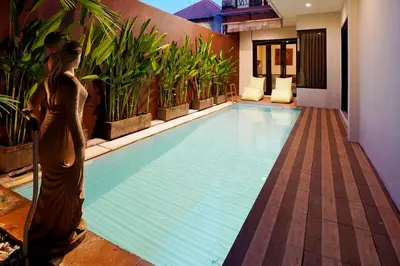 a swimming pool in a villa with a statue in the middle at 3 Bedrooms Villa with Pool WEST SANUR - Casa Del Lago in Sanur
