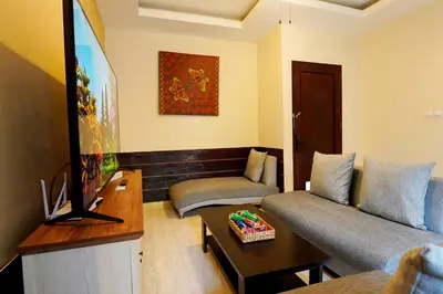 a living room with a couch and a flat screen tv at 3 Bedrooms Villa with Pool WEST SANUR - Casa Del Lago in Sanur