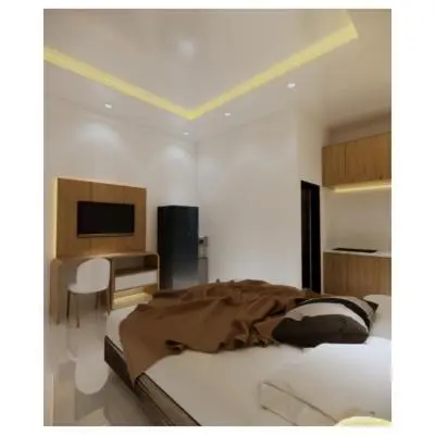 a bedroom with a bed and a desk with a computer at Moonlit Haven in Jimbaran