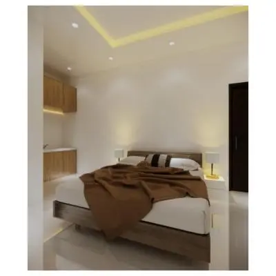 a bedroom with a bed with white walls at Moonlit Haven in Jimbaran