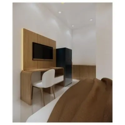 a room with a desk and a chair and a television at Moonlit Haven in Jimbaran