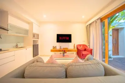 a living room with a couch and a table at Daiva Comfortable 1 BR Private Pool Villa in Jimbaran