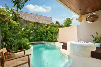 a backyard pool with a hot tub and a hot tub at Alena Cozy 1 BR Private Pool Villa With Lagoon Access in Seminyak