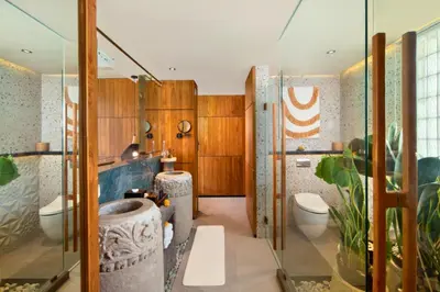 a bathroom with two toilets and a shower at Alena Cozy 1 BR Private Pool Villa With Lagoon Access in Seminyak