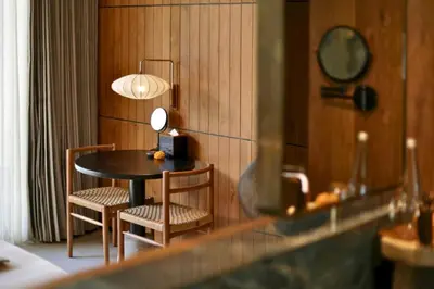 a table with two chairs and a mirror in a room at Alena Cozy 1 BR Private Pool Villa With Lagoon Access in Seminyak