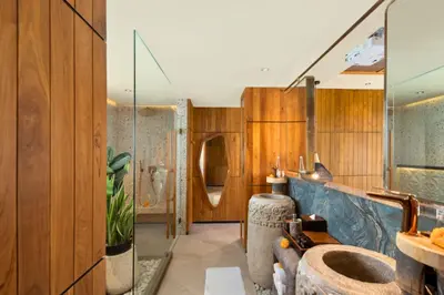 a bathroom with wooden walls and a large sink at Alena Cozy 1 BR Private Pool Villa With Lagoon Access in Seminyak