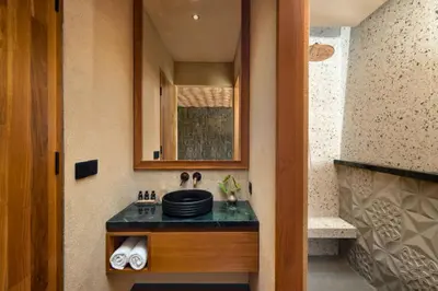 a bathroom with a counter with a sink and a mirror at Alena Cozy 1 BR Private Pool Villa With Lagoon Access in Seminyak