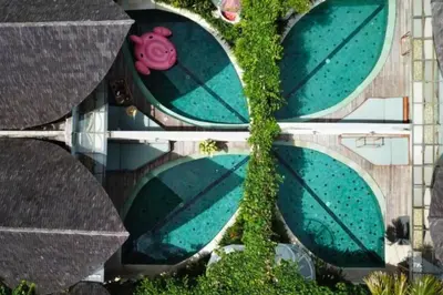 an overhead view of a swimming pool with a tree at Alora Comfortable 1 BR Smart Pool Villa With Jacuzzi in Seminyak