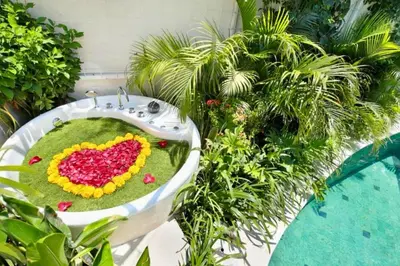 a bathroom sink with a heart made out of flowers at Alora Comfortable 1 BR Smart Pool Villa With Jacuzzi in Seminyak