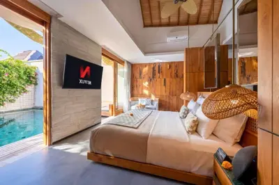 a bedroom with a large bed and a pool at Alora Comfortable 1 BR Smart Pool Villa With Jacuzzi in Seminyak