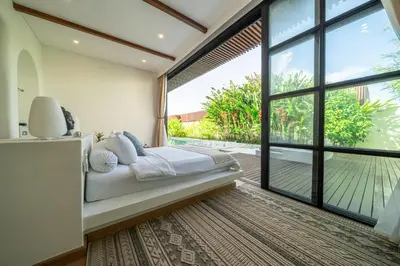 a bedroom with a bed and a large window at Palm Sugar 2-Chic 3BR Villa in Jimbaran with Pool&Garden in Jimbaran