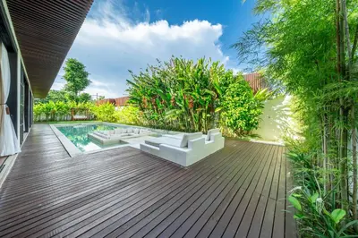 a patio with white furniture and a pool at Palm Sugar 2-Chic 3BR Villa in Jimbaran with Pool&Garden in Jimbaran