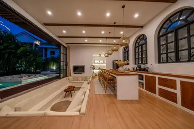 a kitchen and living room with a bar and a pool at Palm Sugar 2-Chic 3BR Villa in Jimbaran with Pool&Garden in Jimbaran