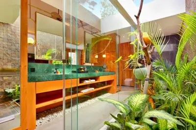 a bathroom with a glass shower and some plants at Charity Stunning Grand 1 BR Pool Villa With Jacuzzi in Seminyak