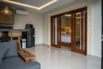 a living room with a couch and a bedroom at Villa Inges 3 Seminyak in Seminyak