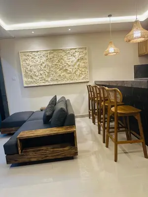 a living room with a couch and a table and chairs at Villa Inges 3 Seminyak in Seminyak