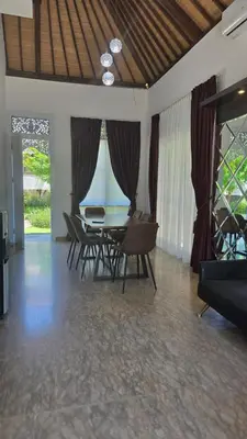 a dining room with a table and chairs at Villa Don Bose 8 in Jimbaran