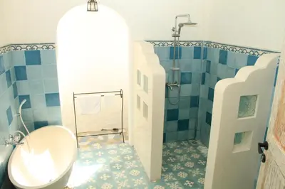 a bathroom with a toilet and a shower at M-Apartment in Badung