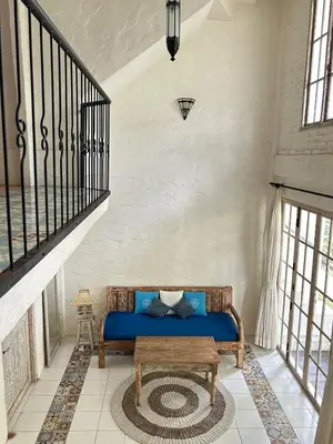 a blue couch in a room with a staircase at M-Apartment in Badung