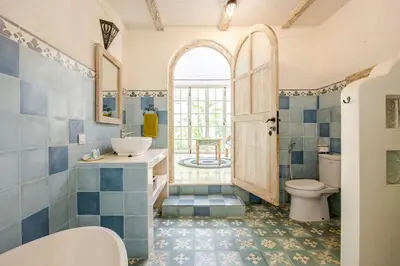 a bathroom with a toilet and a sink at M-Apartment in Badung