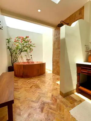 a room with a tub with a plant in it at Casa Mañana Villa Legian, Kuta in Legian