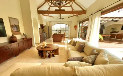 a living room with a couch and a table at Casa Mañana Villa Legian, Kuta in Legian