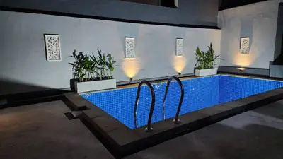 a swimming pool with plants in a building at House of Tomolowicz in Jimbaran