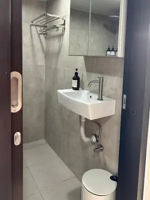 a bathroom with a sink and a toilet at Olive Athena Guesthouse in Seminyak