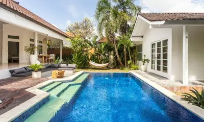 a swimming pool in the backyard of a house at Villa VITA in Seminyak