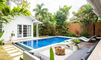 a swimming pool in the backyard of a house at Villa VITA in Seminyak