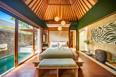 a bedroom with a bed and a pool at Edna Royal 1 BR Private Pool Villa With Jacuzzi in Legian
