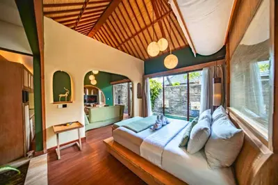 a bedroom with a large bed in a room at Edna Royal 1 BR Private Pool Villa With Jacuzzi in Legian