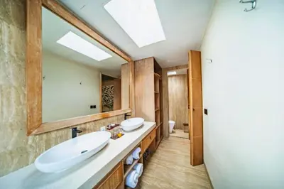 a bathroom with two sinks and a large mirror at Edna Royal 1 BR Private Pool Villa With Jacuzzi in Legian