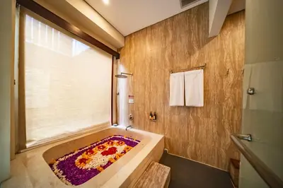 a bathroom with a bath tub with a flower rug at Azula Cozy Royal 2 BR Private Pool Villa With Jacuzzi in Legian
