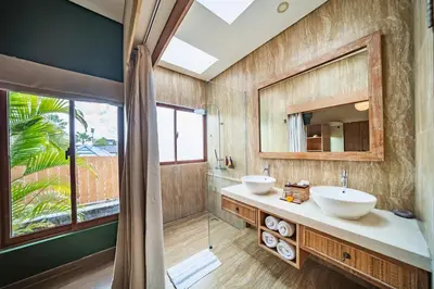 a bathroom with two sinks and a mirror at Azula Cozy Royal 2 BR Private Pool Villa With Jacuzzi in Legian