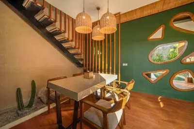 a dining room with a table and a staircase at Azula Cozy Royal 2 BR Private Pool Villa With Jacuzzi in Legian