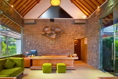 a living room with a table and green chairs at Azula Cozy Royal 2 BR Private Pool Villa With Jacuzzi in Legian