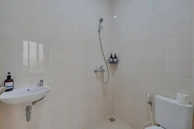 a bathroom with a shower and a sink and a toilet at 3BR Villa Taman Seminyak 27 - Short Drive to Beach in Seminyak