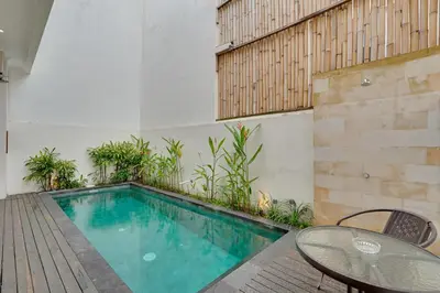 a swimming pool with a table and a table and chairs at 3BR Villa Taman Seminyak 27 - Short Drive to Beach in Seminyak